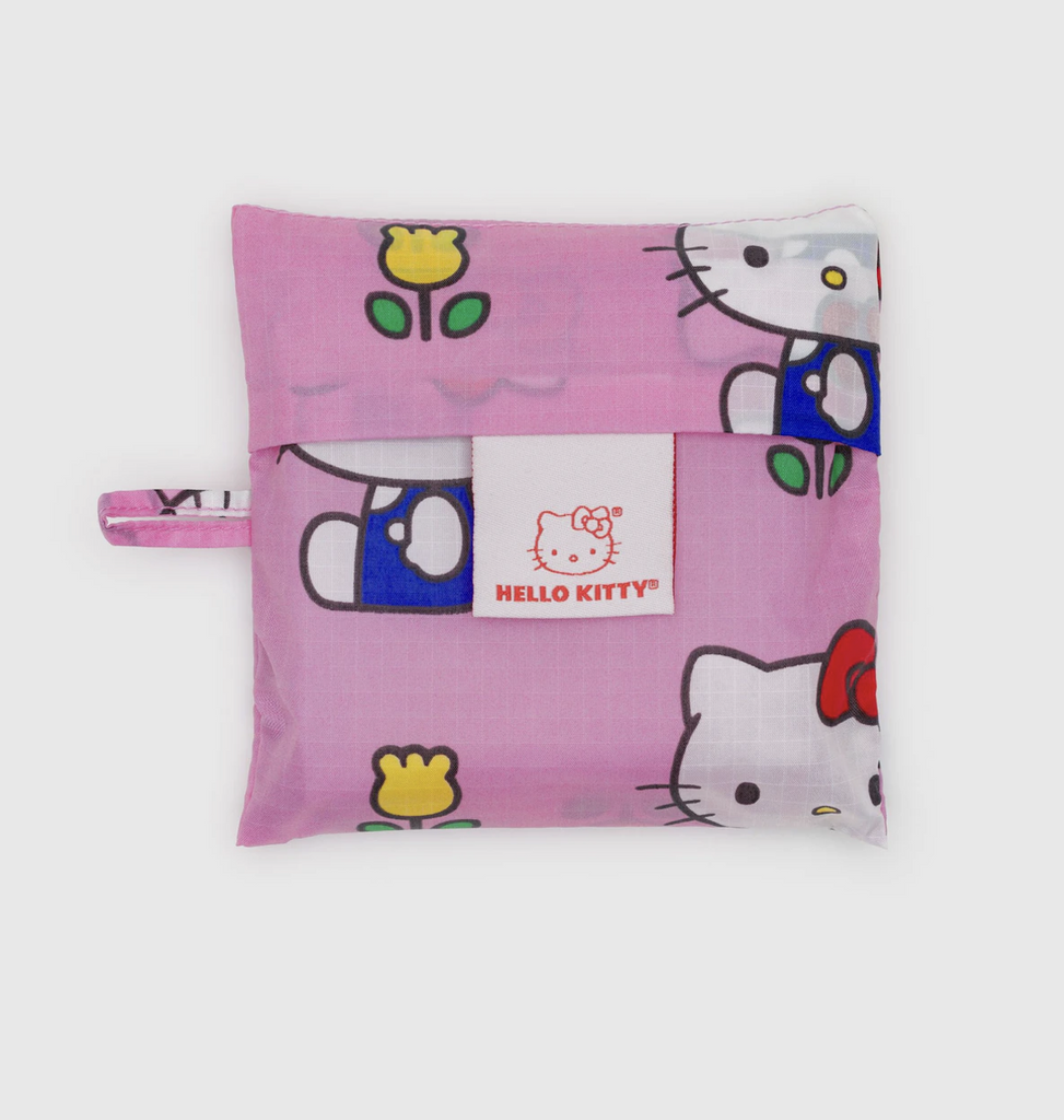 The standard Baggu reusable bag folded and placed in its storage pouch with the same pattern that is on the bag. 