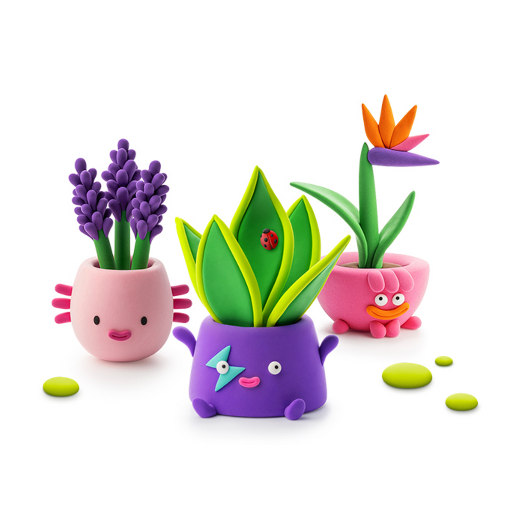 Three clay plant pots with colorful flowers. Choose one of the three to make with the Hey Clay Plant Folks kit. 