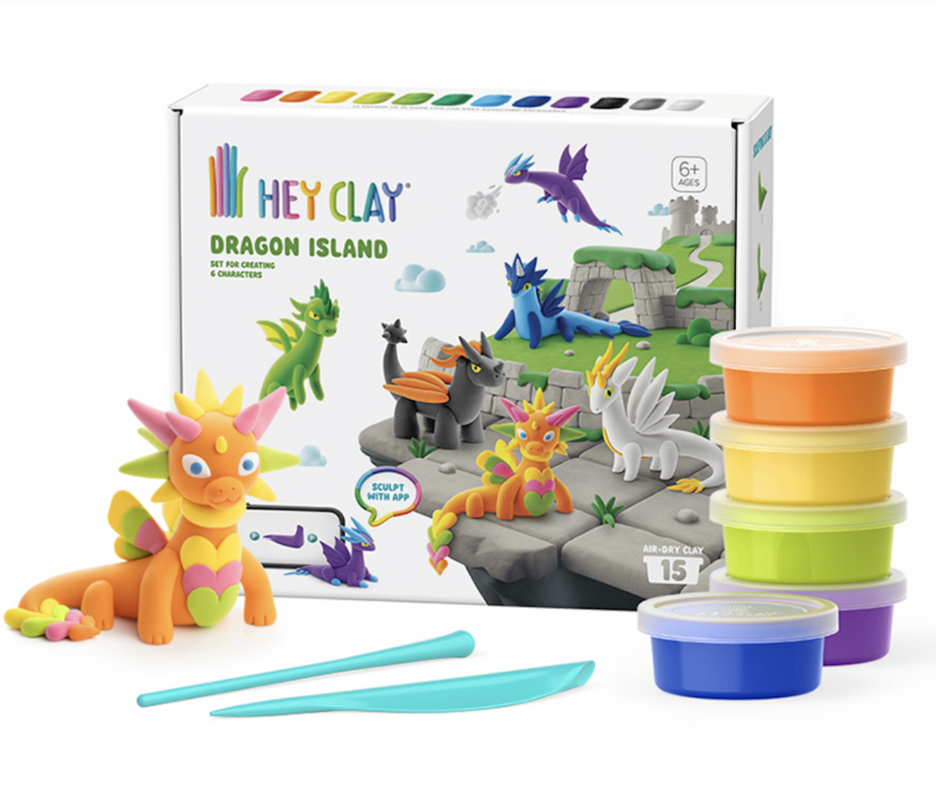 The Hey Clay Dragon Island kit packaged in a box with pictures of each of the different dragons that can be made, one orange and yellow dragon, sculpting tools and enough clay to make one dragon with each kit. 