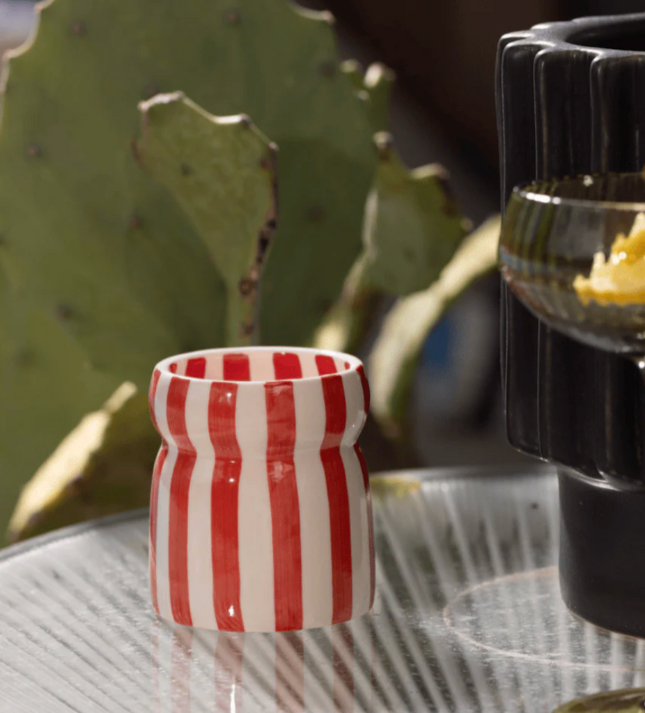 Hibiscus Bay scented candle by Paddywax on a patio table. 