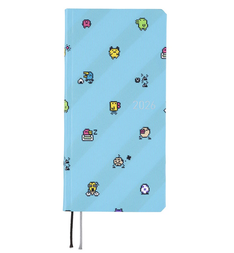 The Hobonichi Techo Tamagotchi 2026 Weeks Planner with a light blue textured cover with Tamagotchi characters all over it. 