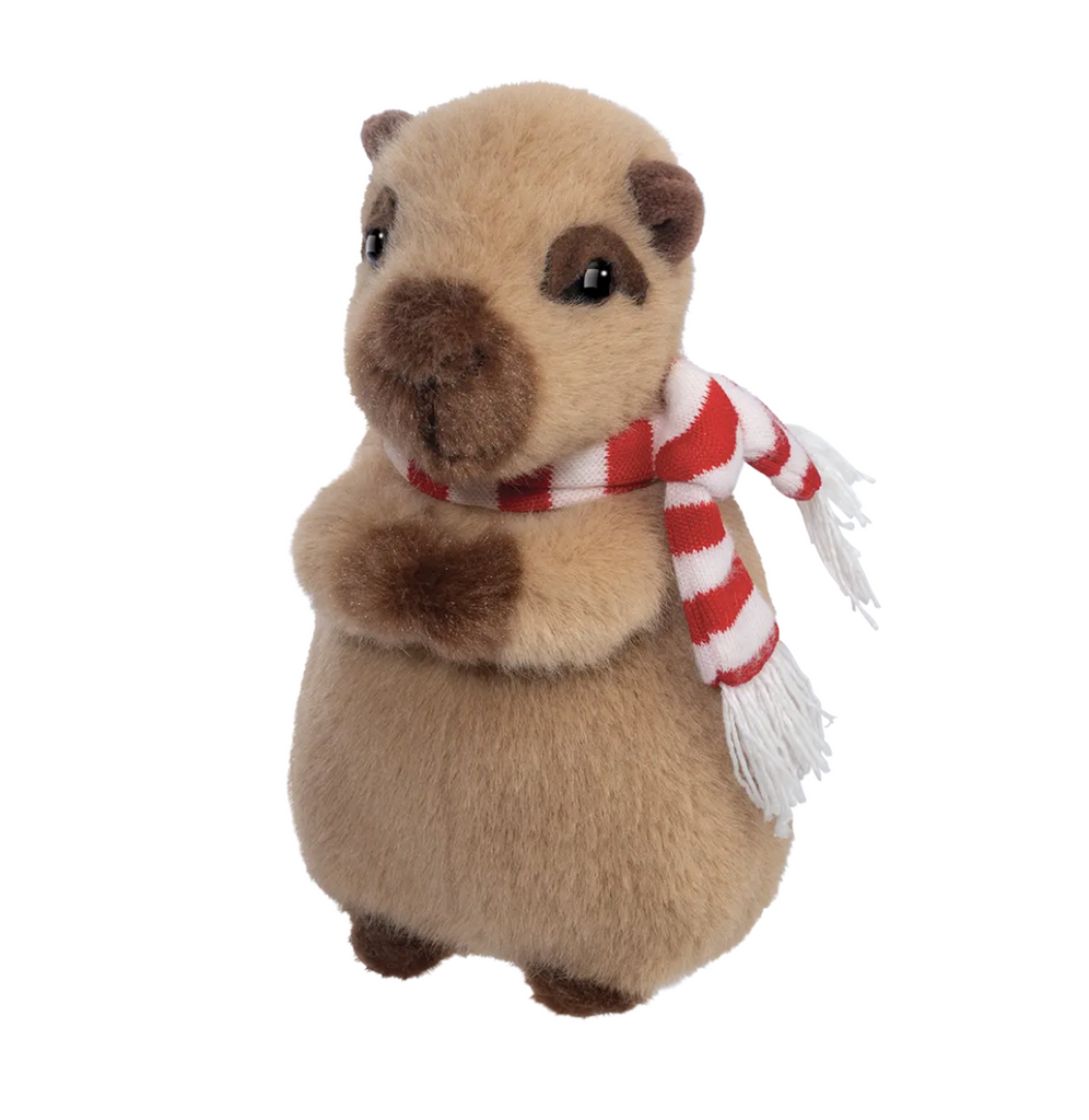 The cutest little Capybara stuffed animal wearing a red and white striped scarf and resting back on it's hind feet. 