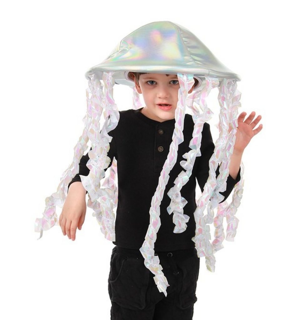 The Holographic Jellyfish Plush Hat is a foam disk is covered in a stunning iridescent fabric that shimmers and shines, with iridescent tentacles hanging from the edge of foam disk being worn by a child. 