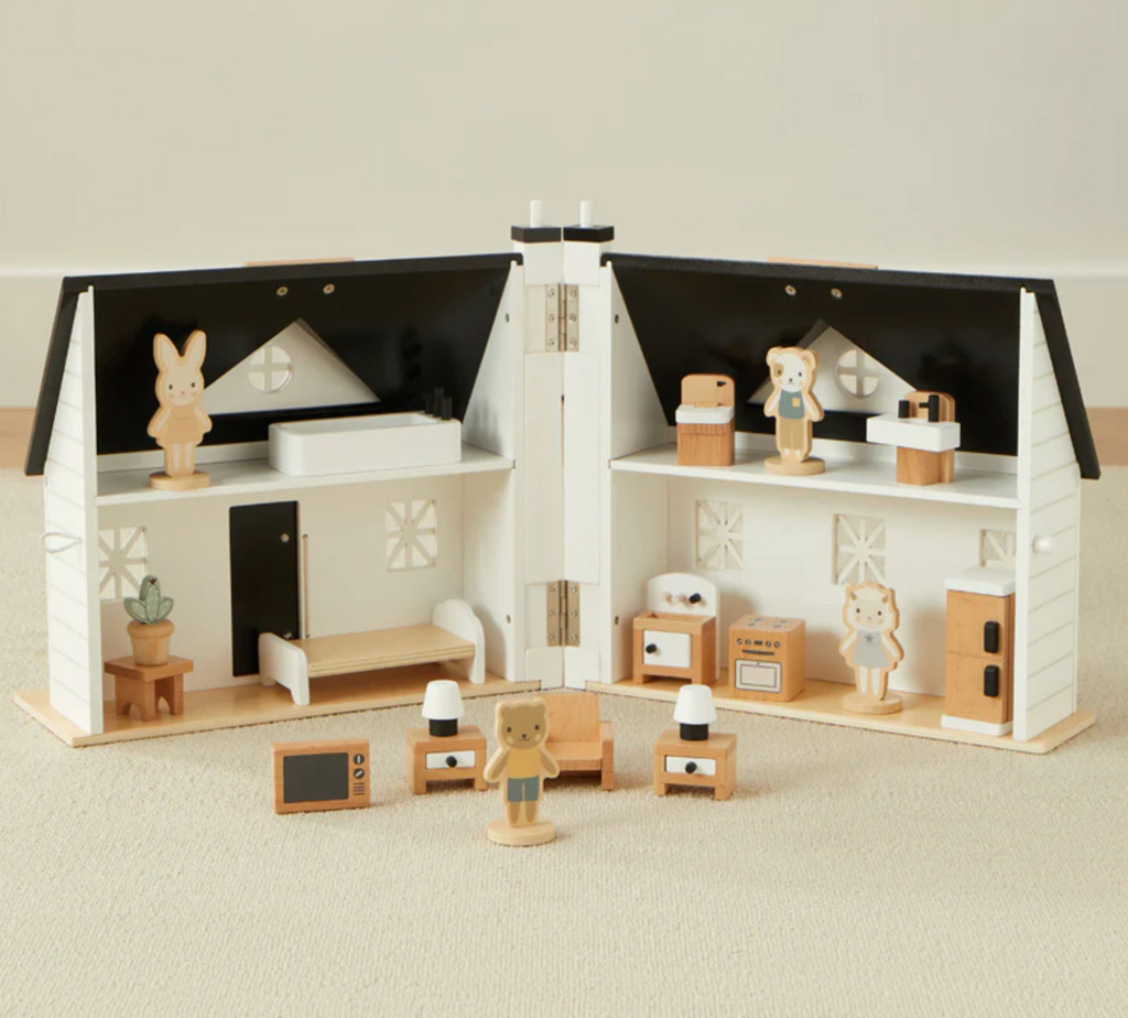 Wooden dollhouse opened to show the interior with furniture and toy figures on a neutral background. 