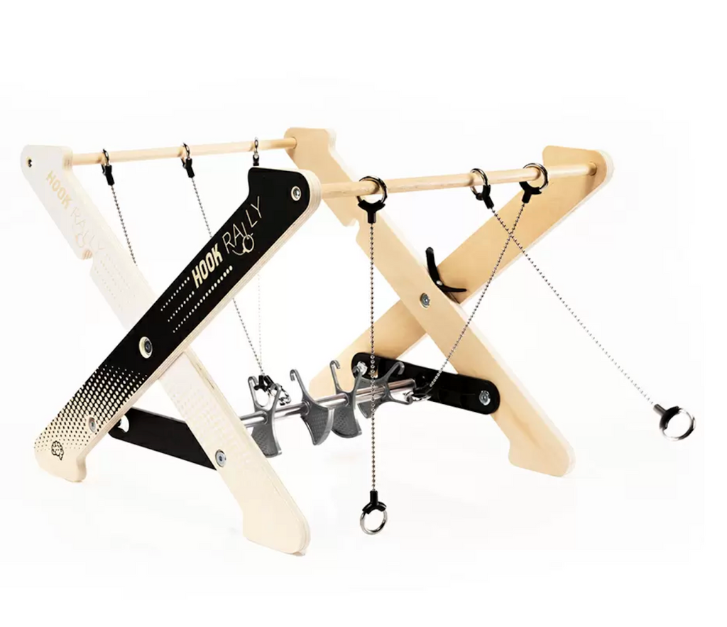 Hook Rally hook  and ring race game set up and in motion.There is one ring secured on a hook and one ring swinging through the air in attempt to land on the hook. 