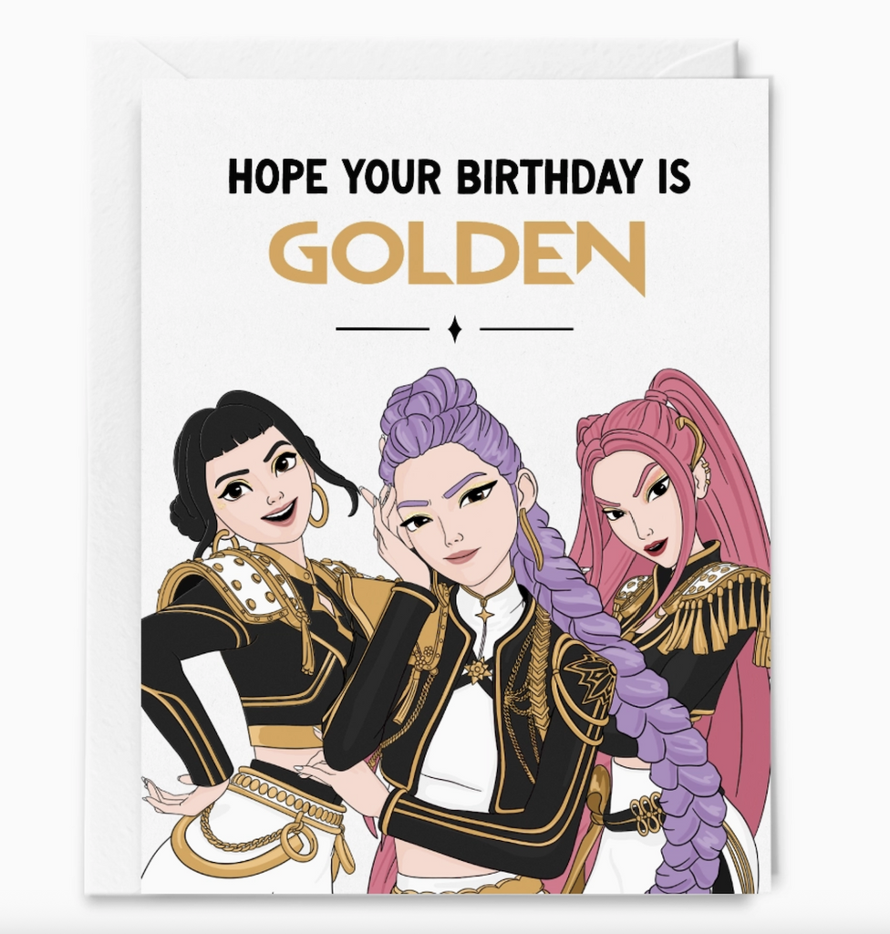 Illustrated greeting card with K-pop group Huntrix (Rumi, Mira, Zoey) featured on the front. The card reads "Hope your birthday is Golden" 