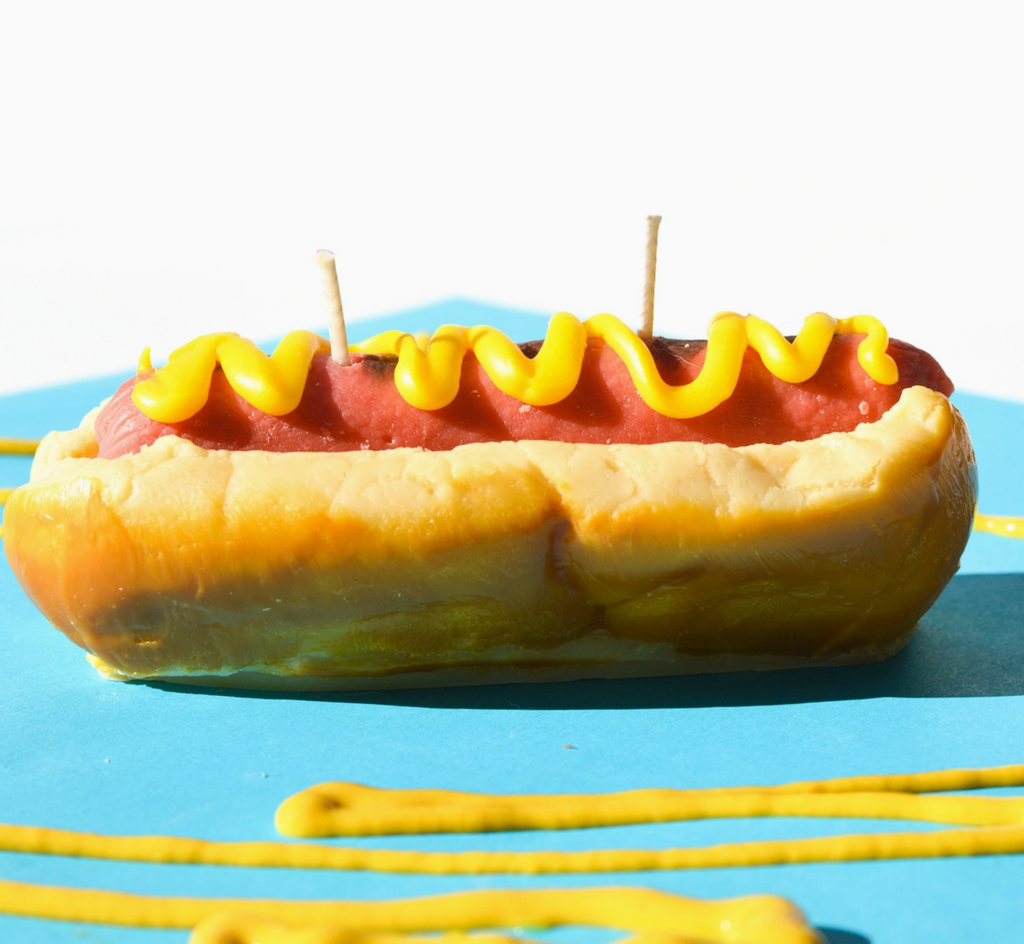 Hot dog with mustard candle. 