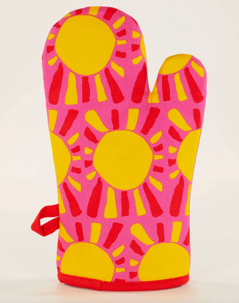 Palm side of the "Hot Shit" oven mitt with repeating sun graphics. 