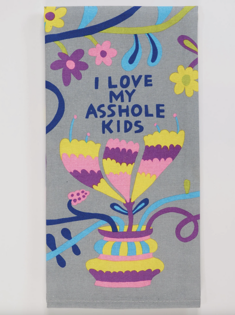 Folded kitchen towel with floral graphics that read "I Love My Asshole Kids"