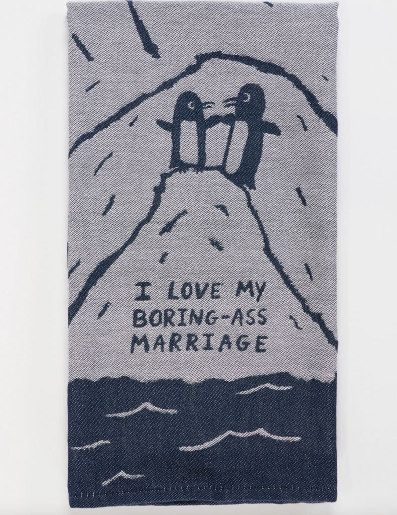 Denim blue woven dish towel with two penguins atop an iiceberg that reads "I Love My Boring Ass Marriage"