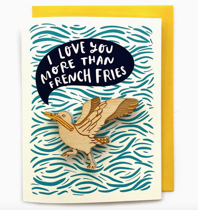 Greeting card with blue swirl pattern that reads "I Love You More Than French Fries" with a removeable seagull with a fry in it's mouth magnet.