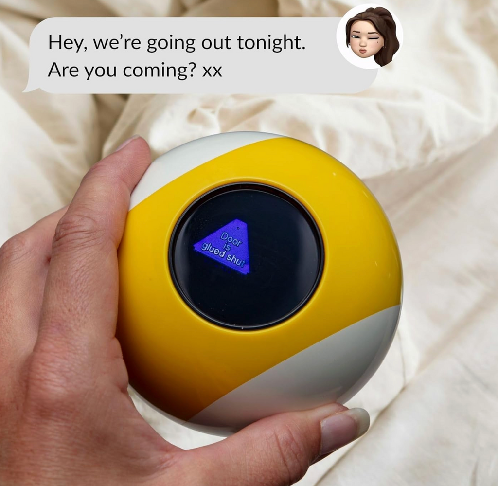 Hand holding a yellow and white excuse ball, with the answer revealed as "Door is glued shut" at the top of the picture is text that reads "Hey, we're going out tonight. Are you coming?"