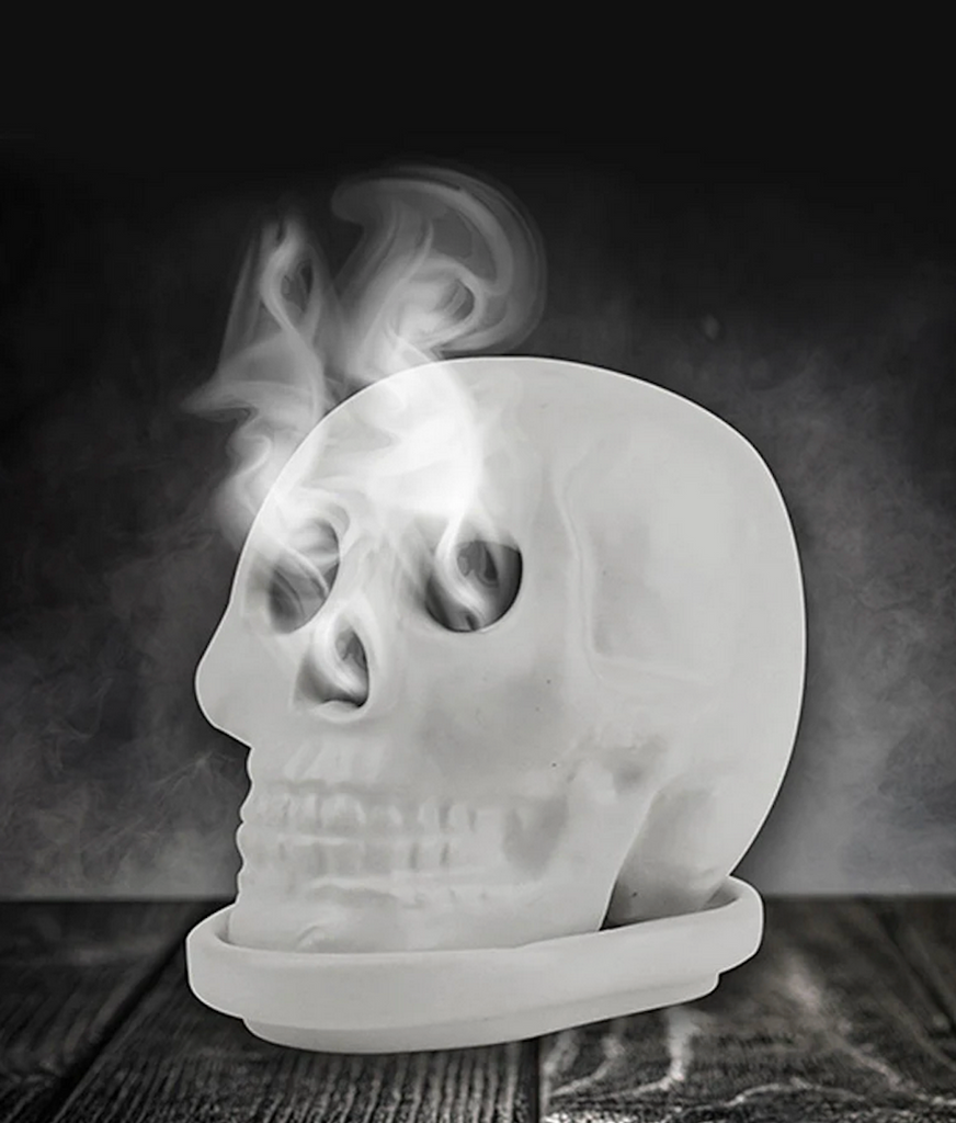 The Skull Incense holder with smoke coming out of it's eyes and nose. 