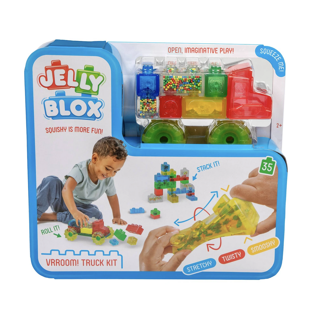 A bright blue box with pictures of children playing with vehicles made using the Jelly Blox Vroom Truck Kit. There are also pictures of some of the blocks stacked together and a yellow block being twisted and stretched to show how squishy they are. The box also has a clear section showing a variety blocks from the set as well as wheels and the truck cab. 
