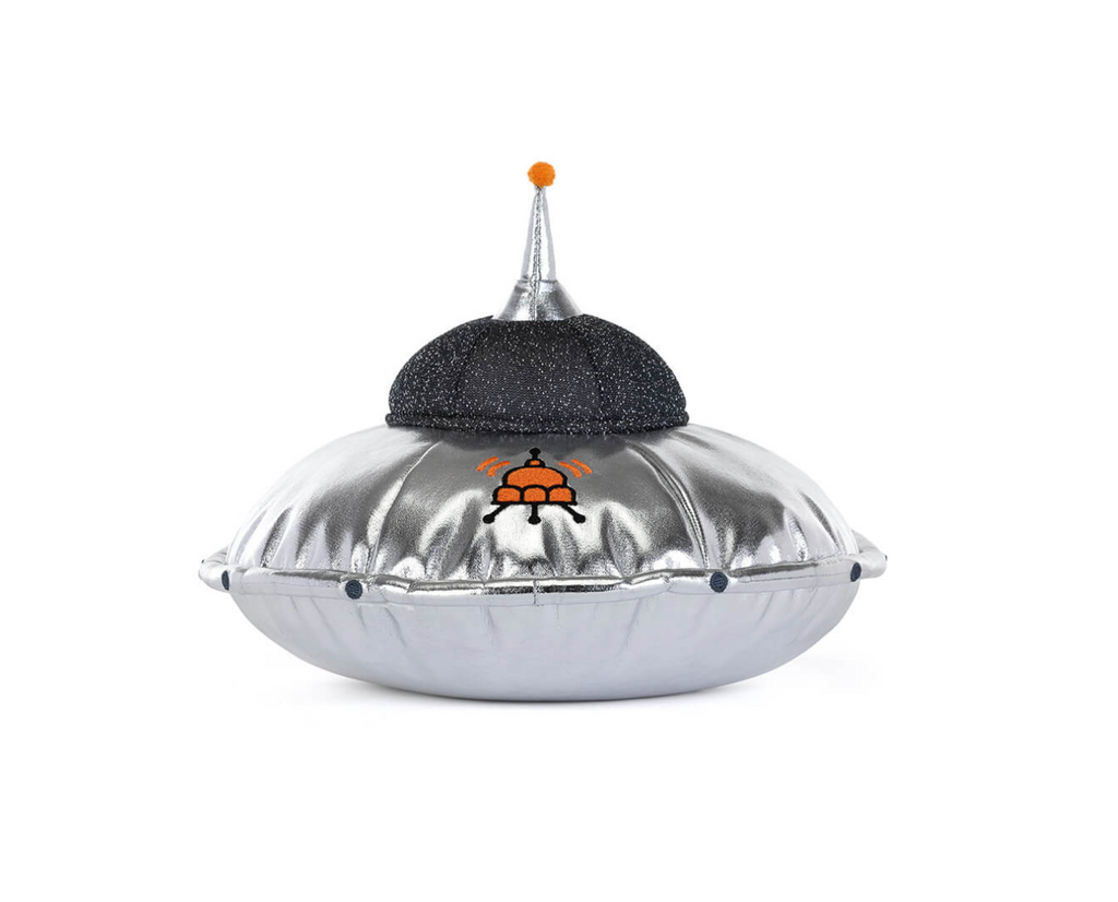 A silver plush flying saucer-shaped cushion with a black mesh top and a small orange logo in the center, isolated on a white background.