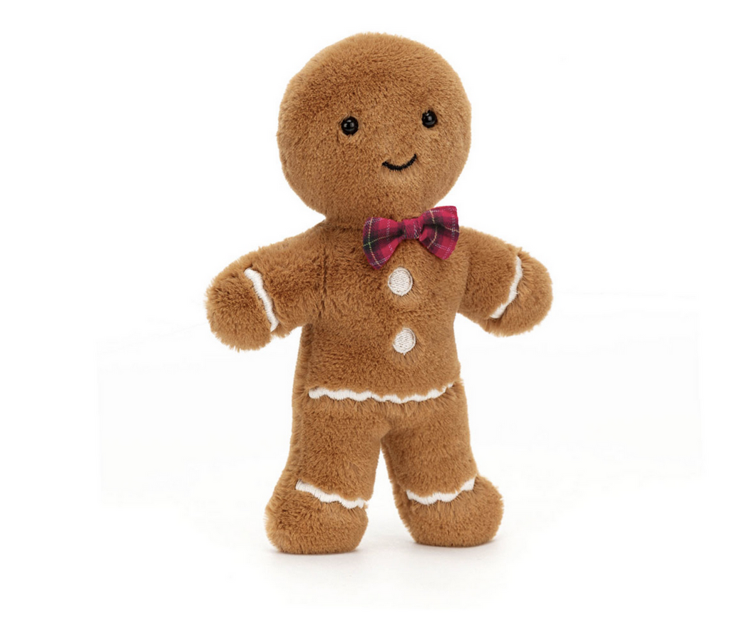 Plush brown gingerbread man with a red bowtie on a white background.