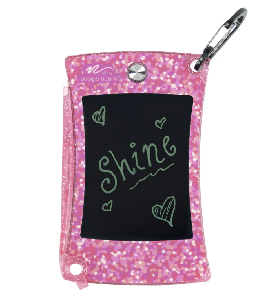 Jot Pocket Writing Tablet in Shimmer Pink with the clip used to attach it to backpacks, purses, or your coat. 