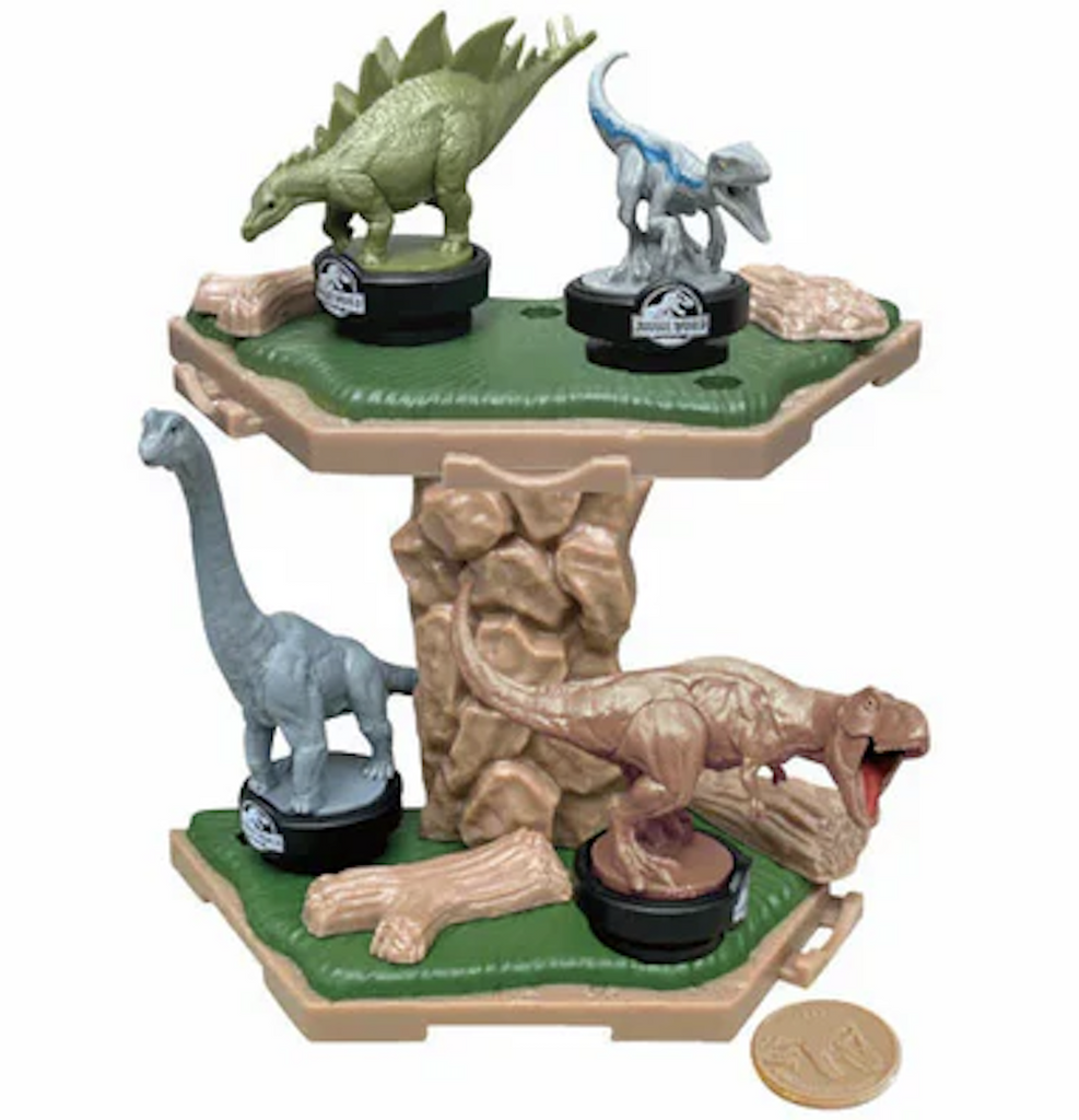 Tabletop Jurassic World Island Quake game with four dinosaur figures perched on the island game piece. 