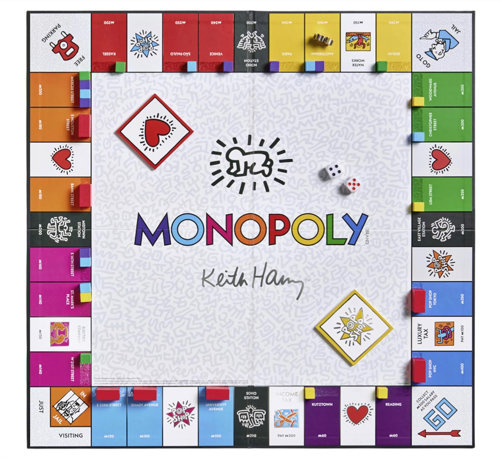 Monopoly board game with colorful Keith Haring artwork, metal tokens, custom Monopoly money, “Pop Shop” and “Heart” cards, and properties named after locations tied to Haring’s life and legacy. 