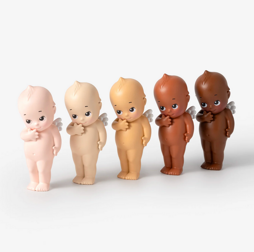 Five Kewpie Tones figures in different skin tones on a white background.