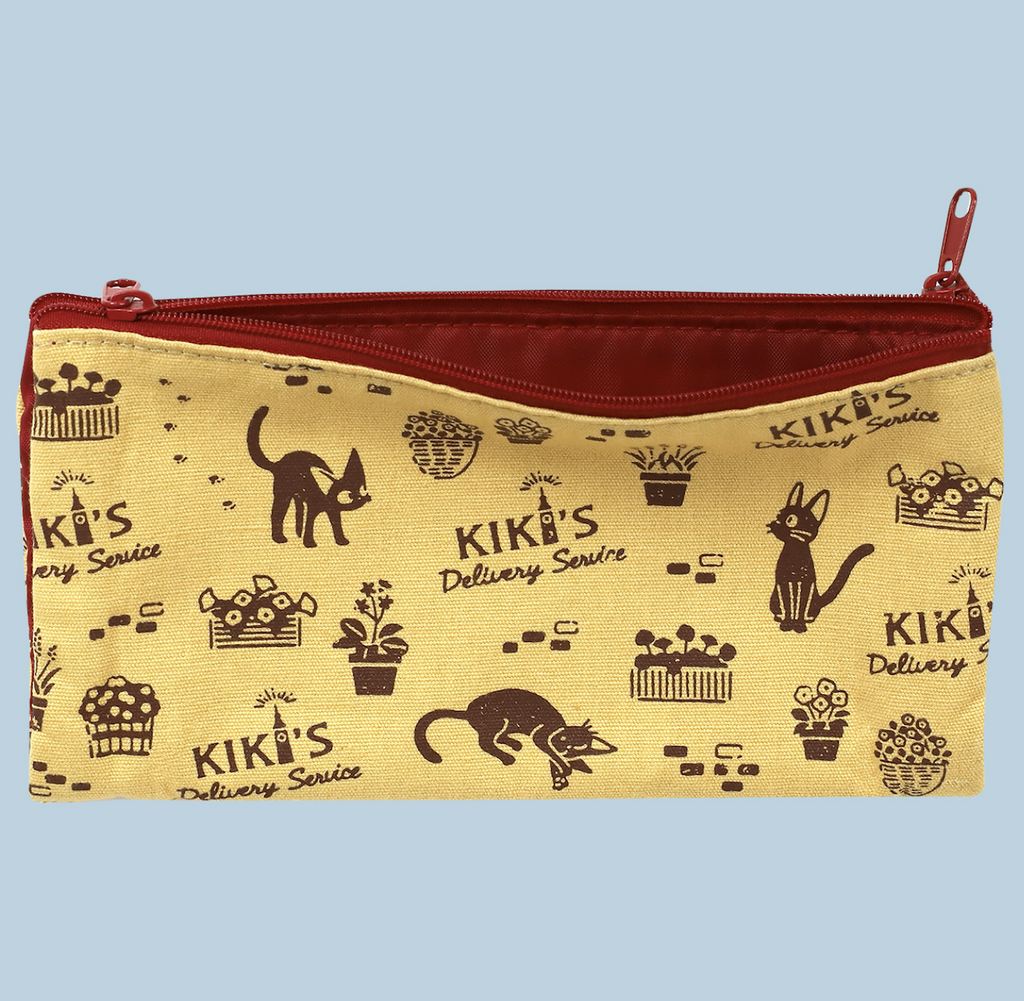 Zippered Kiki's Delivery Service Pen Case with a pale yellow fabric and brown illustrations of potted flowers, and Jiji the cat. The zippers and interior are brick red. 