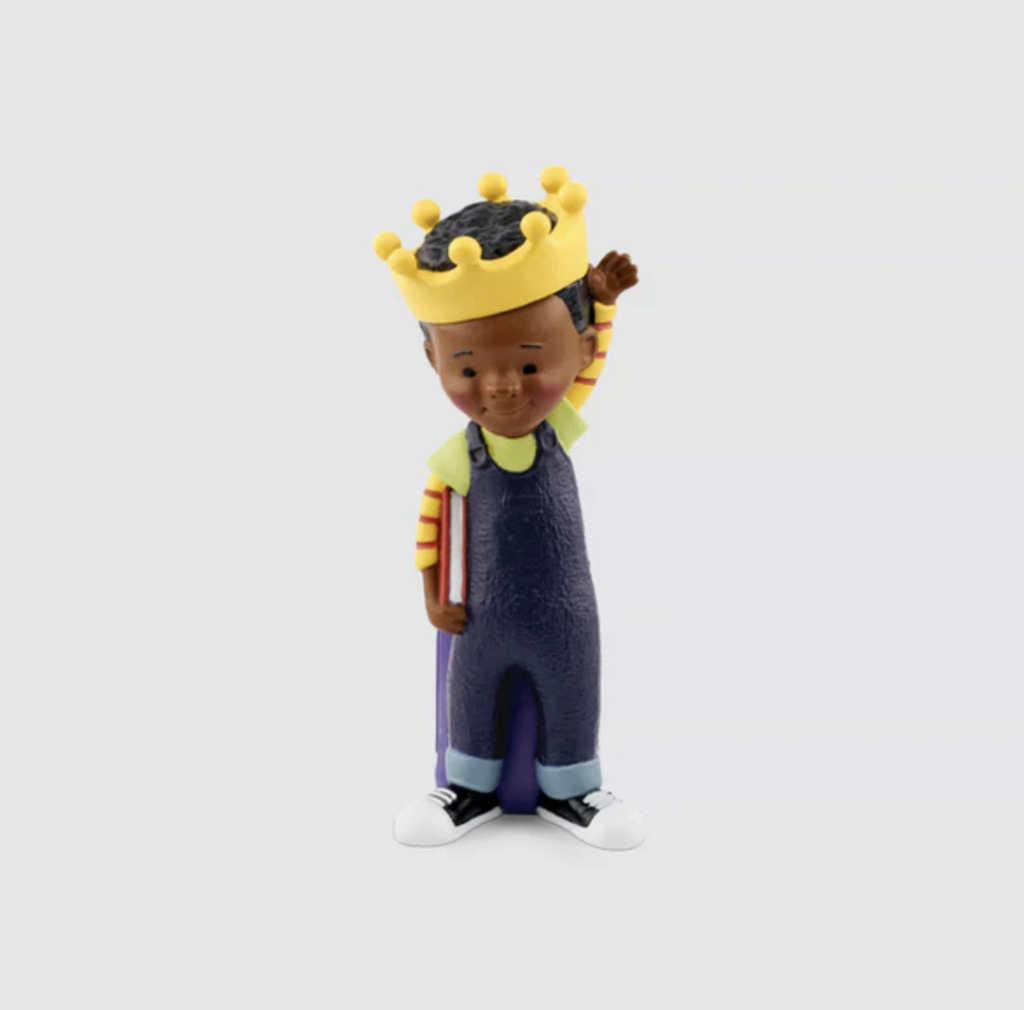 King of Kindergarten Tonie figure of a Black boy wearing a yellow crown, dark blue overalls, and a yellow and red striped shirt holding a book.