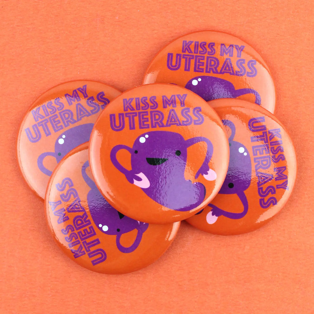 A pile of "kiss My UterAss" magnets.