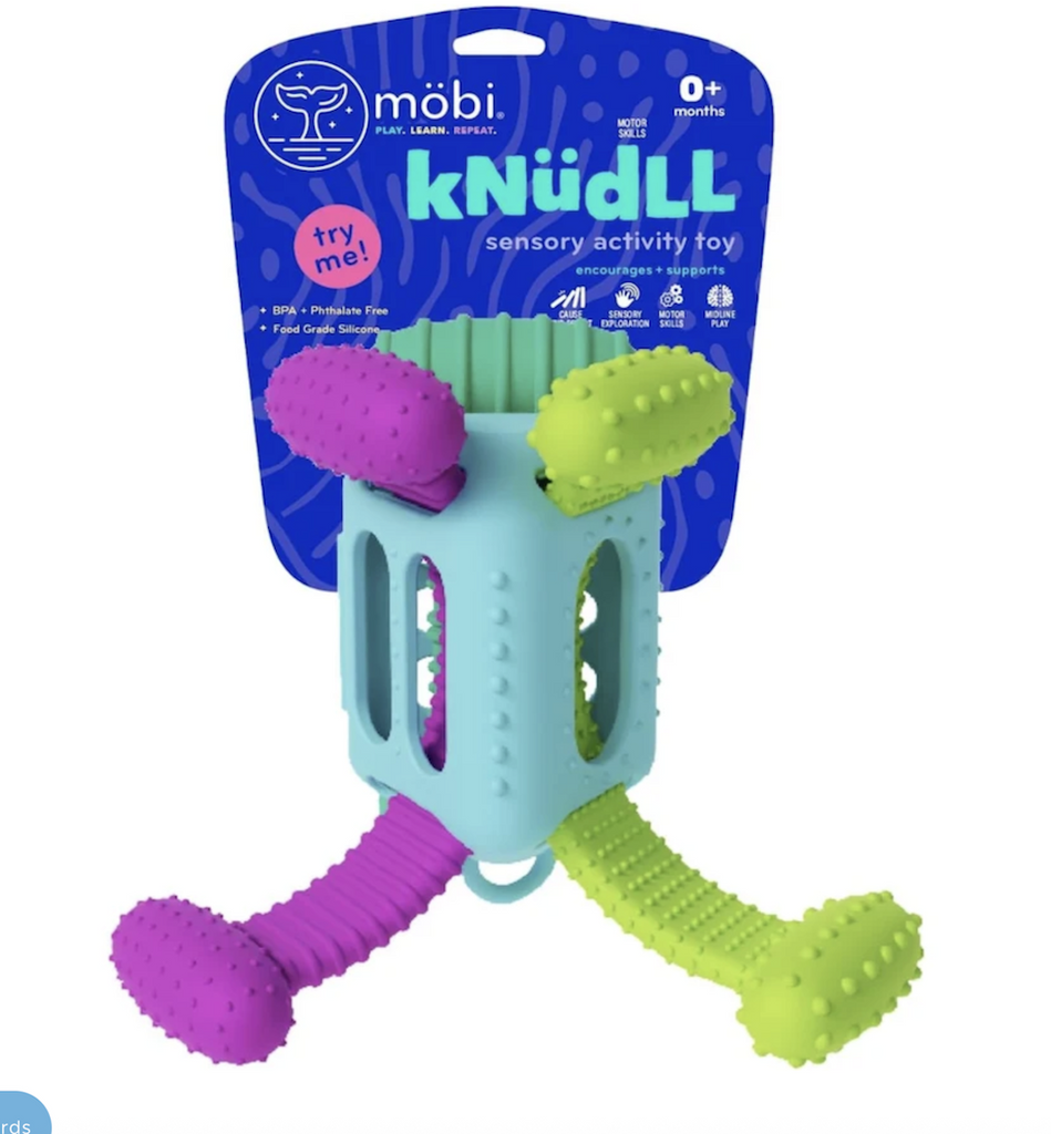 Knudll Sensory Activity Toy for babies attached to a blue hang card that allows all the textures and features of the toy to be tried out. With purple, green and light blue contrasting colors. 