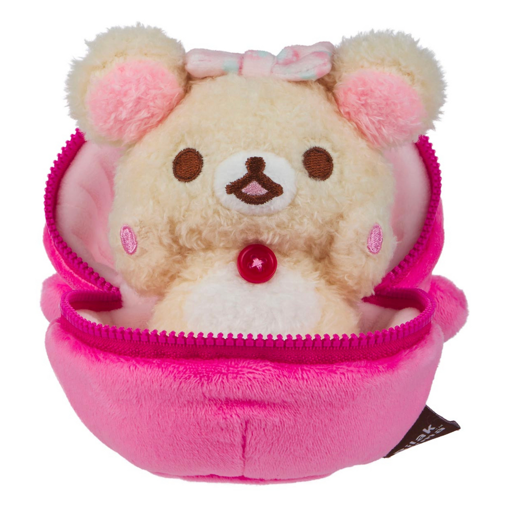 Korilakkuma plush doll sitting inside the strawberry which is open and allowing Korilakkuma to peek out. 