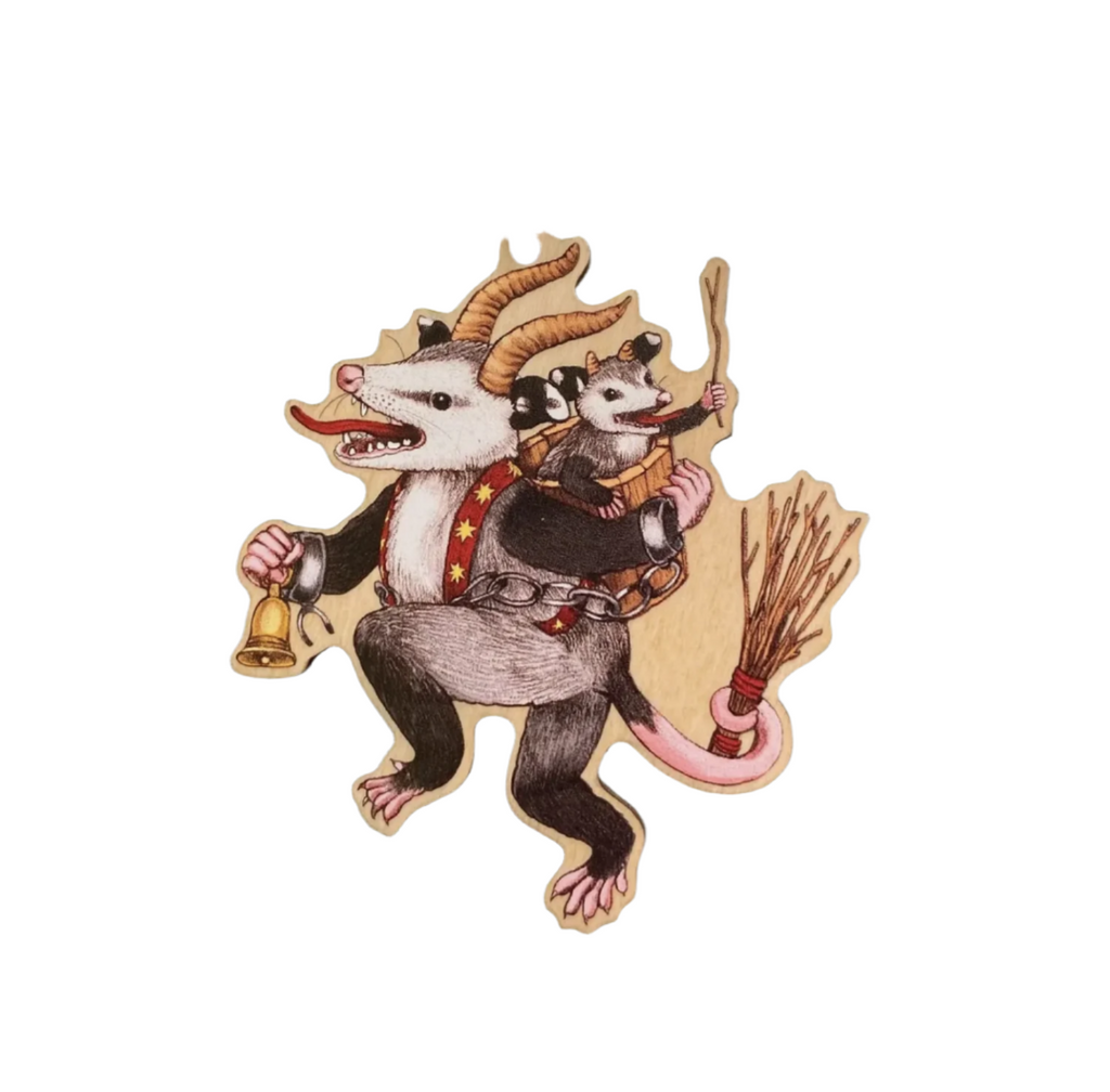 Die-cut wooden ornament of a possum dressed as Krampus with a small possum in the basket on it's back.