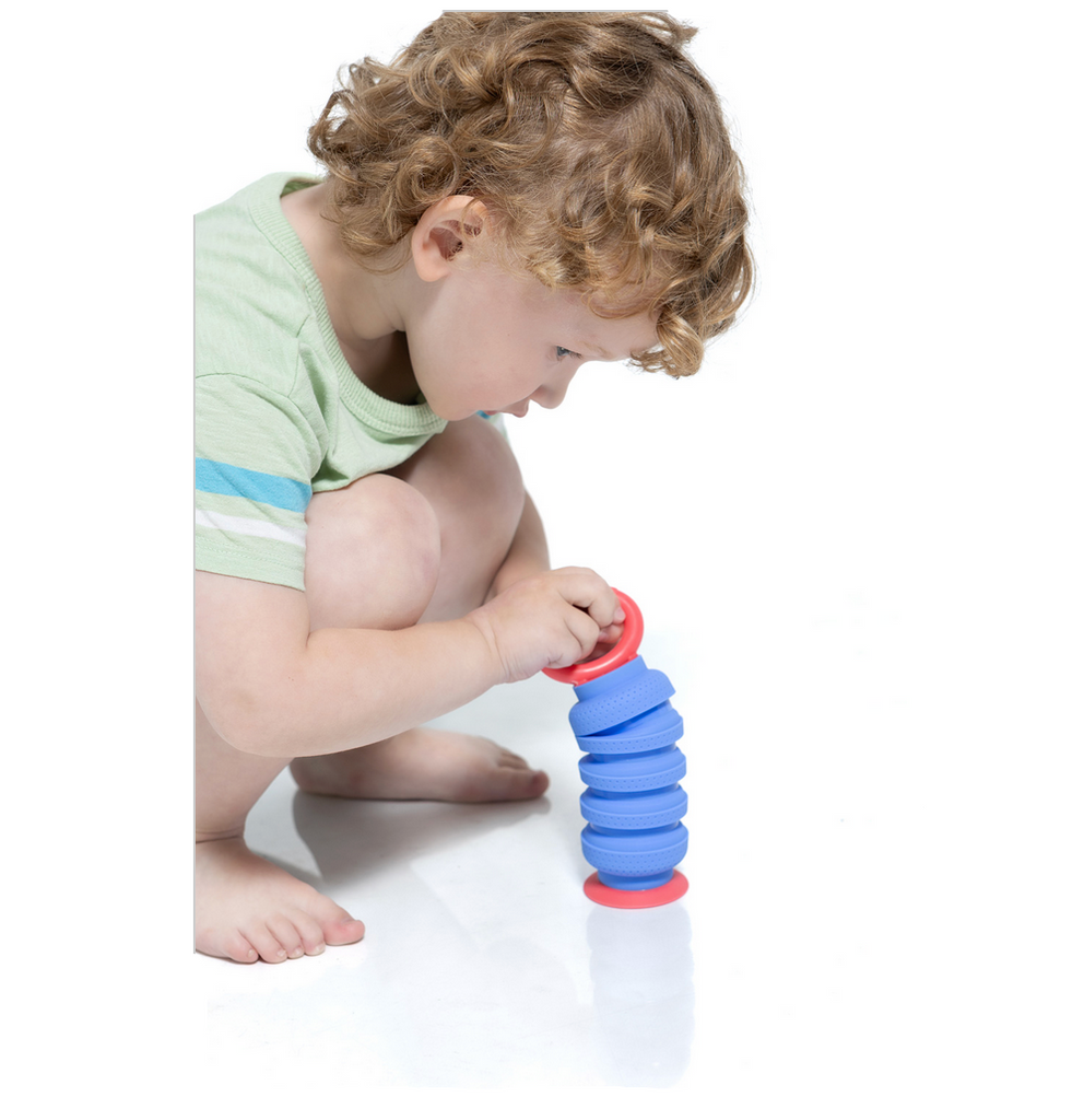 Child squatting down playing with a Krumple Plungy.