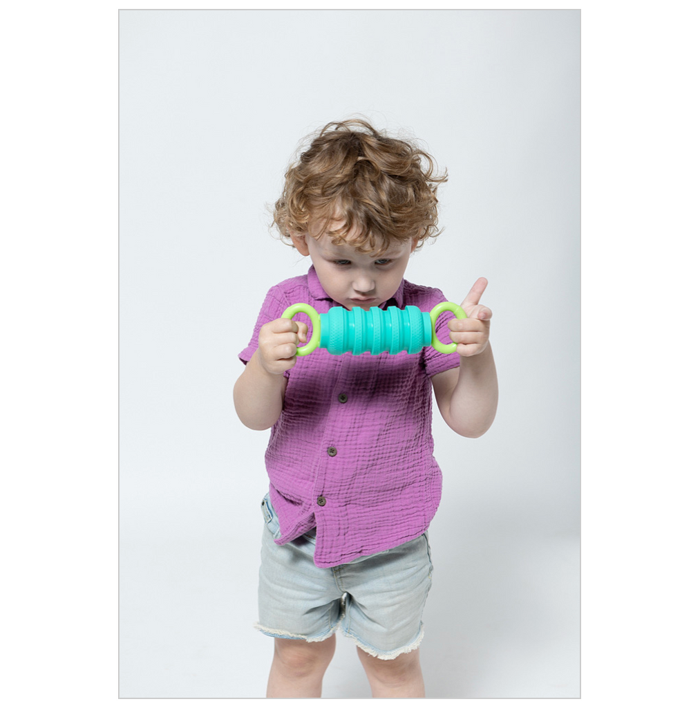 Child squishing a blue and green Krumple Pully in between their hands.