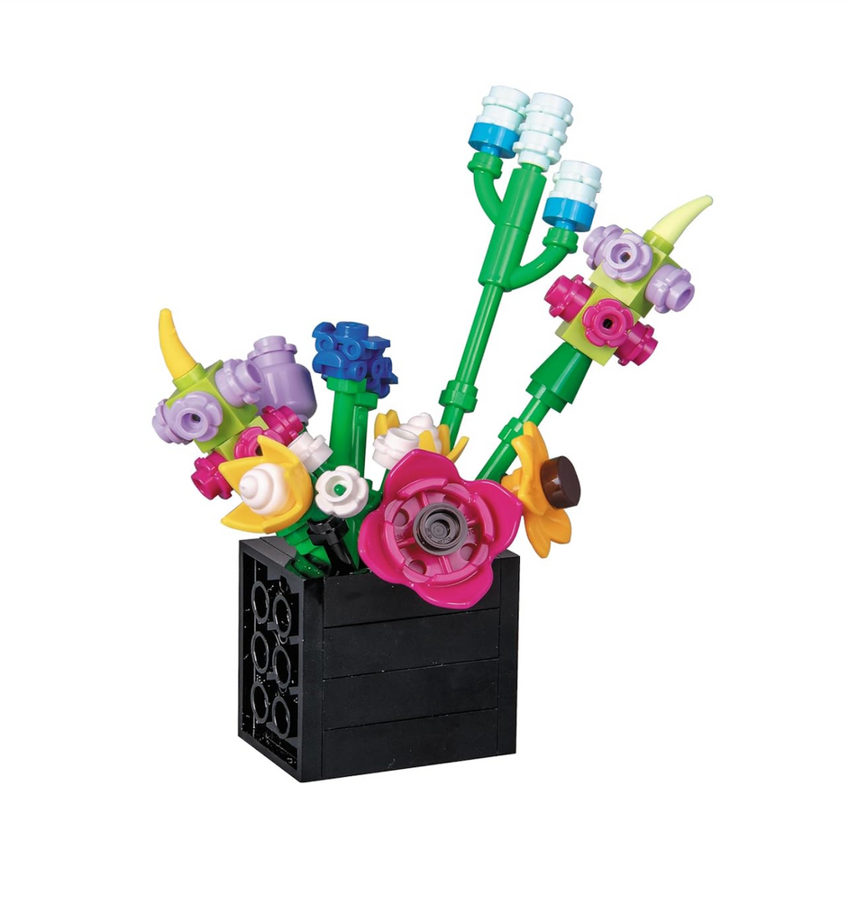 Several brick built tiny wildflowers placed in a black vase built with LEGO's.