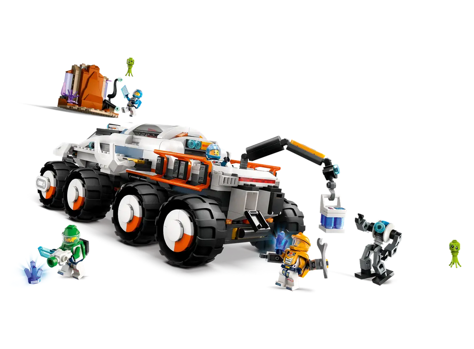 The futuristic 8-wheeled Command Rover vehicle has big tires, sample storage hatches, a crane arm and a pod bay for docking the air-lock laboratory. The included minfigures and robot are also pictured. 