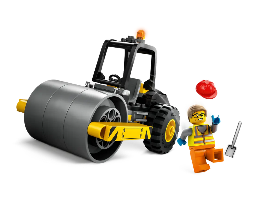 The LEGO Construction Steamroller with the included minifigure standing beside the steamroller with his hardhat and shovel. 