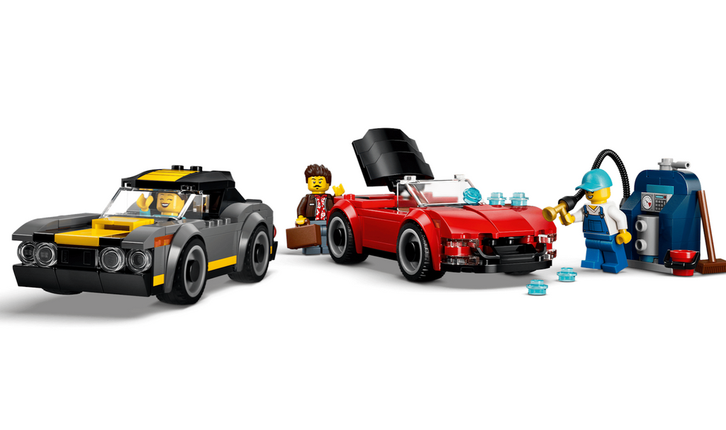 Two LEGO City toy vehicles parked at the vacuum station that is included in the Drive-Through Car Wash building set. 