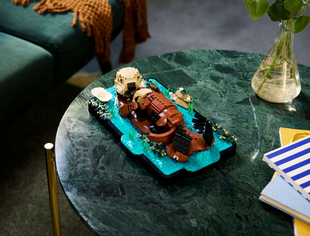 The LEGO Floating Sea Otters set displayed on a green marble coffee table. 
