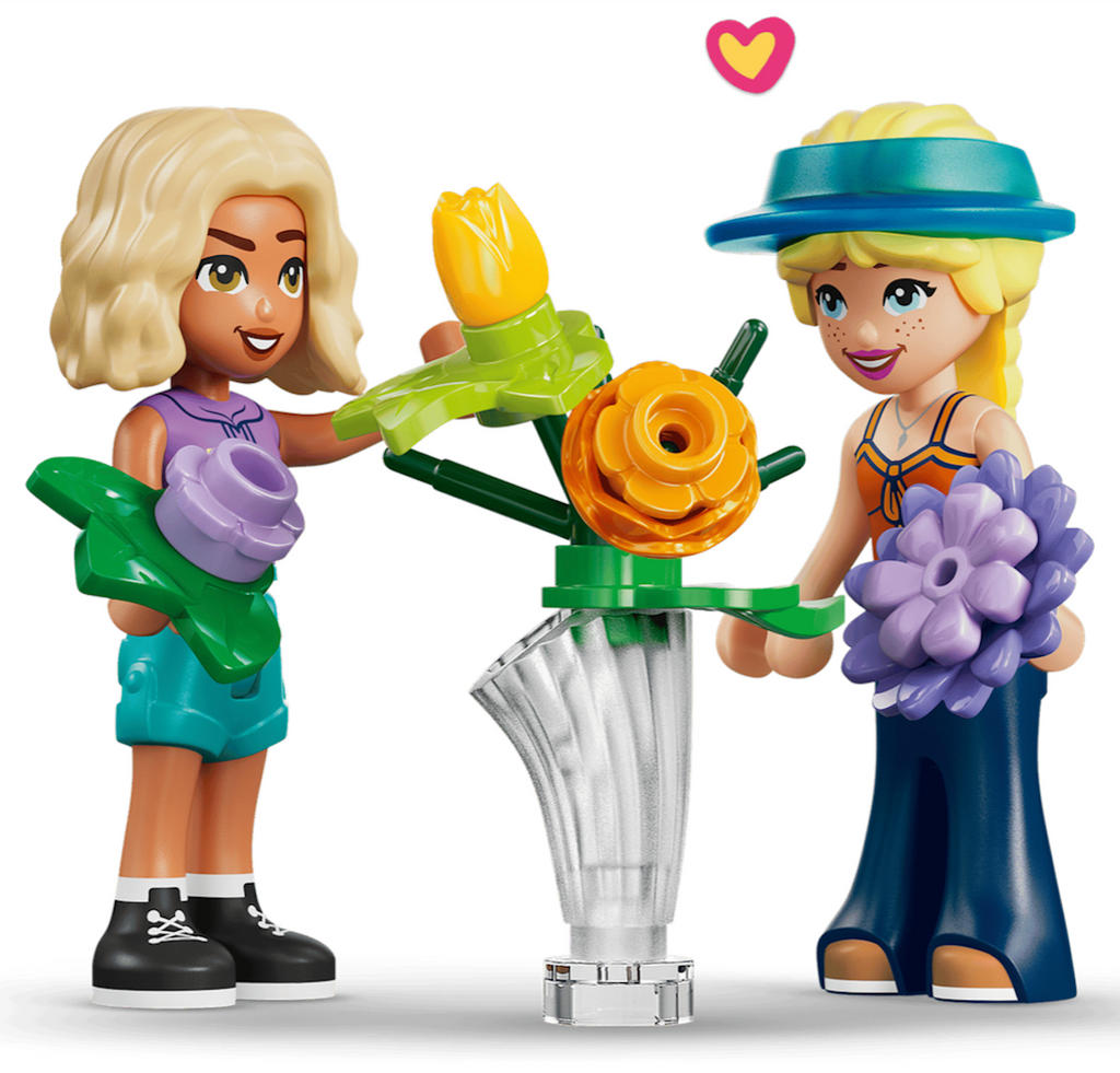 Close up picture of LEGO Friends minidolls Nova and Astrid arranging flowers in a vase. 