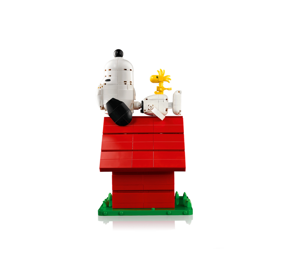 LEGO Ideas Snoopy's Doghouse constructed with red, green, white, yellow and black bricks to make Snoopy's iconic doghouse with him laying on top with his pal Woodstock perched on his stomach. 