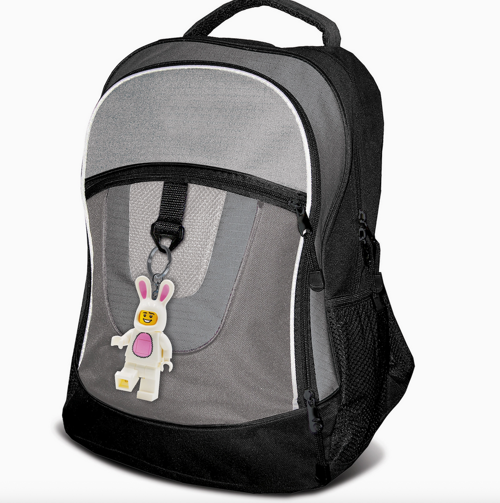 The LEGO LED Keychain Bunny Suit Guy attached to a grey and black backpack. 
