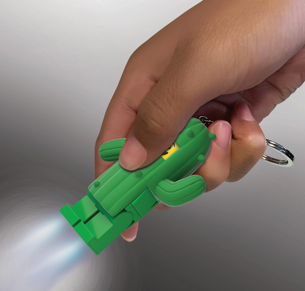 LEGO LED minifigure Cactus Boy keychain being held with the flashlight shining from it's feet. 