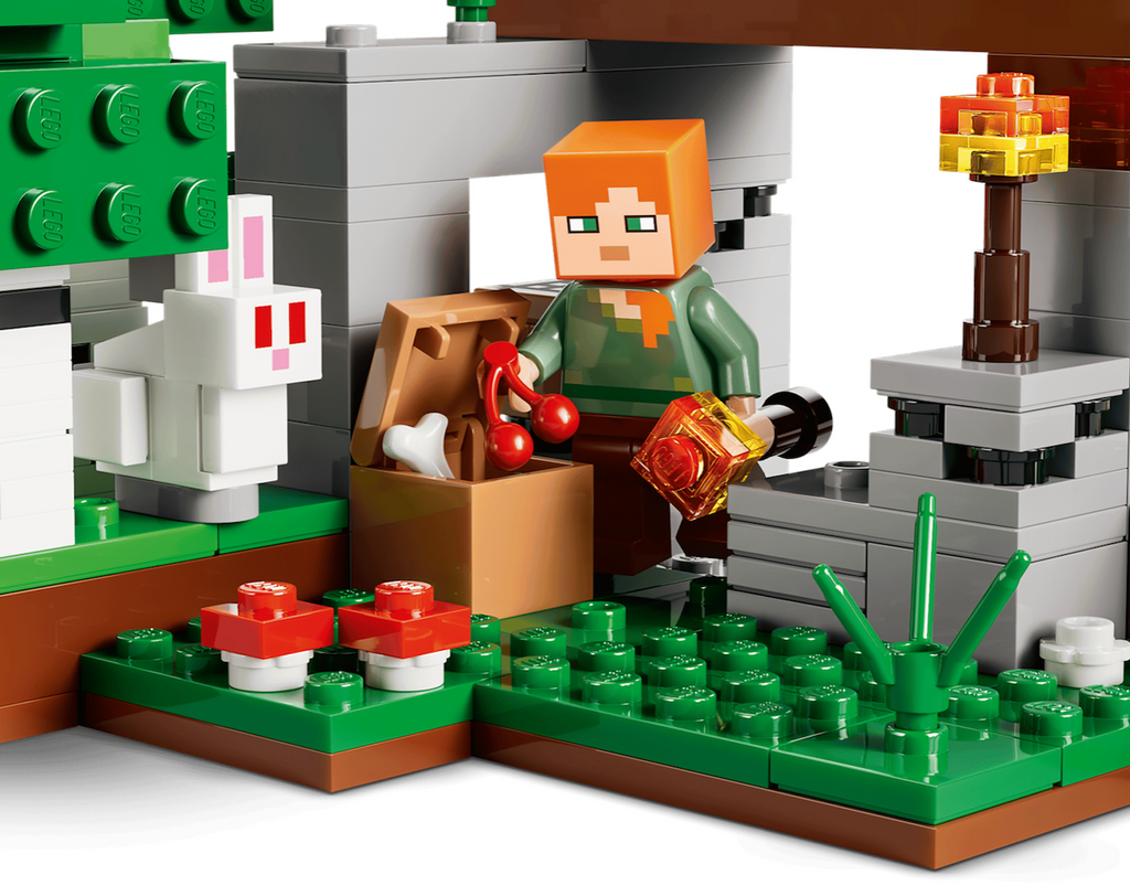 Close up of the LEGO Minecraft First Night Adventure set with Alex holding a torch and berries by the treasure chest. 