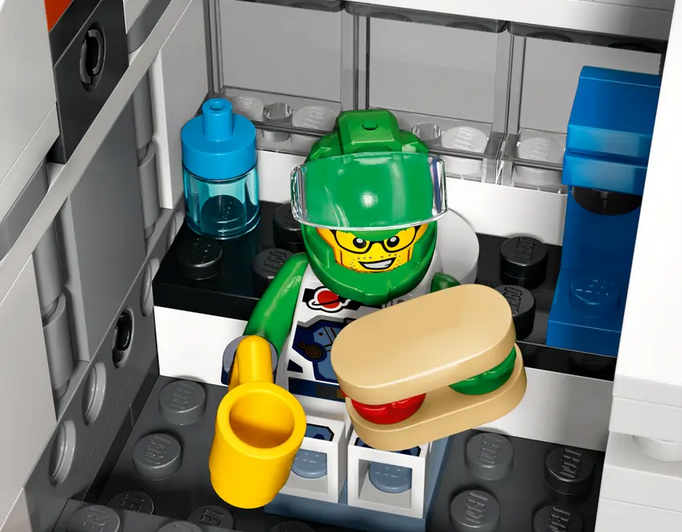 One of the included space crew minifigures in the kitchen module having a bite to eat. 