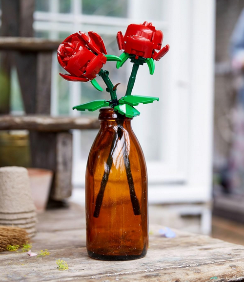 The LEGO Roses built and in a brown vase on a table as room decor. 