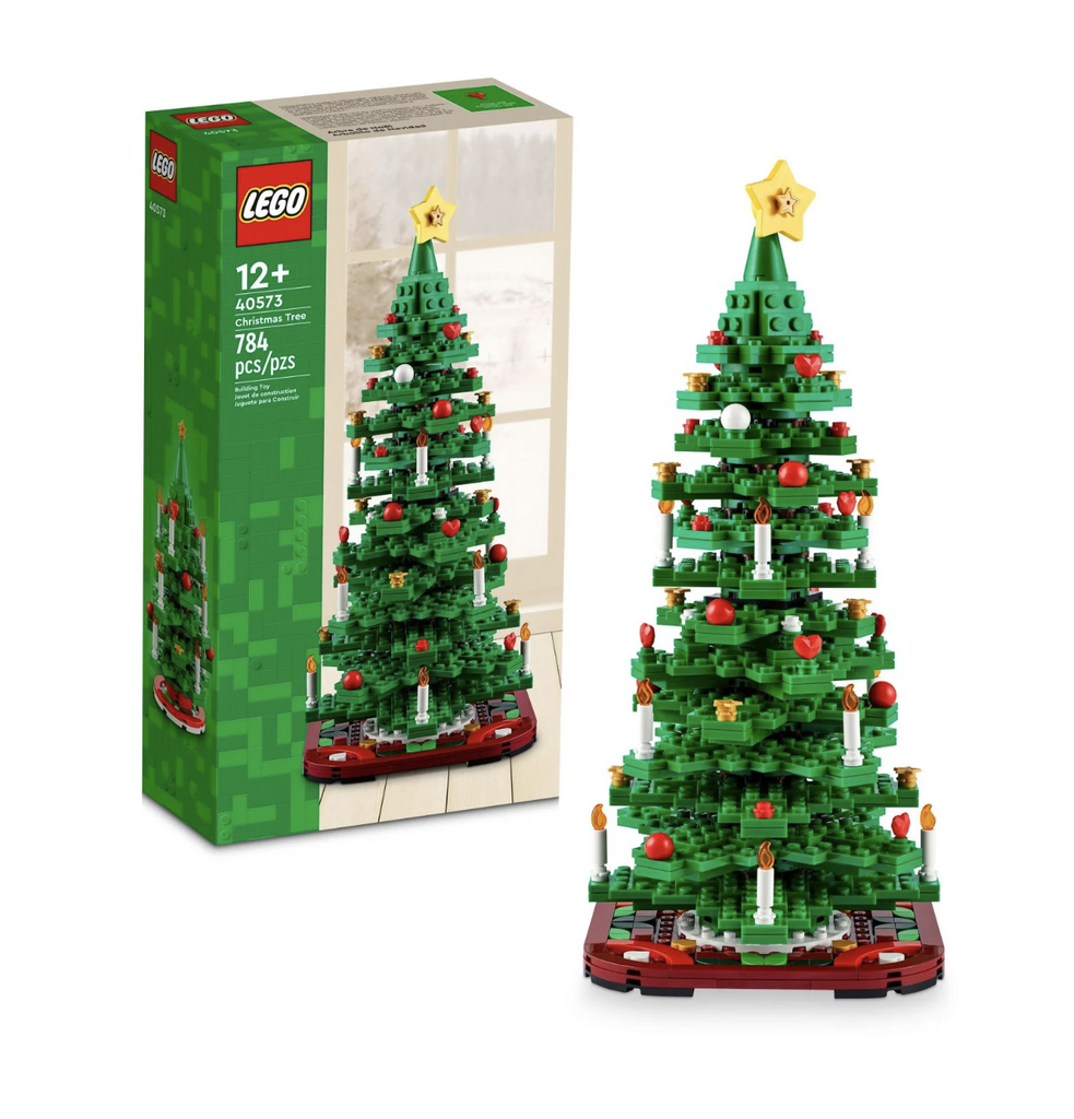 The LEGO Christmas Tree built completely and standing in front of the box with a picture of the completed LEGO build. 