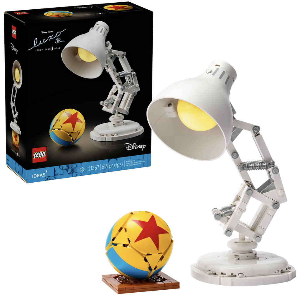 LEGO Disney Pixar model of Luxo Jr. lamp character with the yellow ball with blue stripes and red star set up on front of the black LEGO box it is packaged in. 