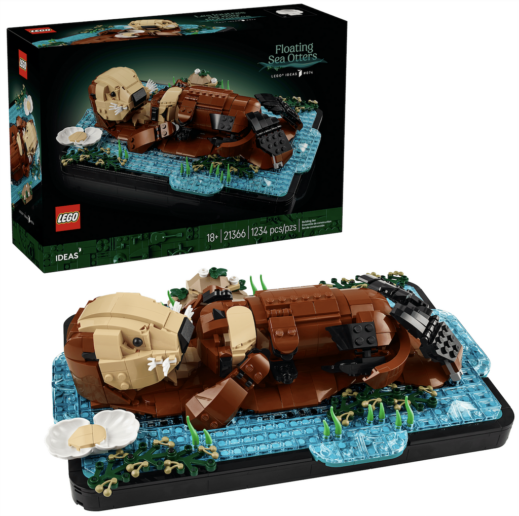 The LEGO Ideas Floating Sea Otters box in the background with the completed brick-built model of a mother sea otter relaxing in water with her pup in front. 