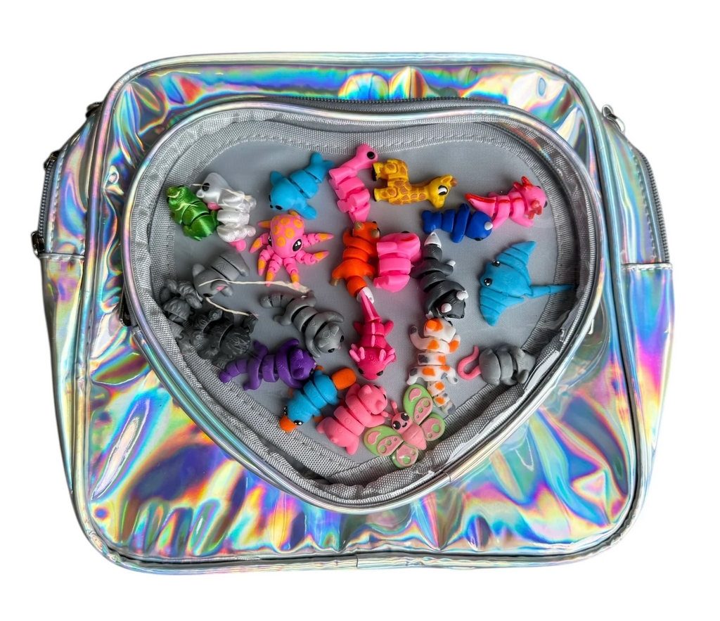 Holographic bag with clear, heart shaped pocket with colorful fidget toys visible inside. 