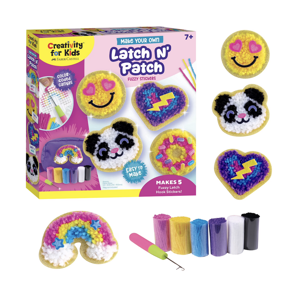 The Latch N' Patch box with pictures of the colorful fuzzy stickers that can be made with the kit. A smiley face, panda bear, heart and rainbow. The latch tool and yarn supply is also featured in front of the box. 