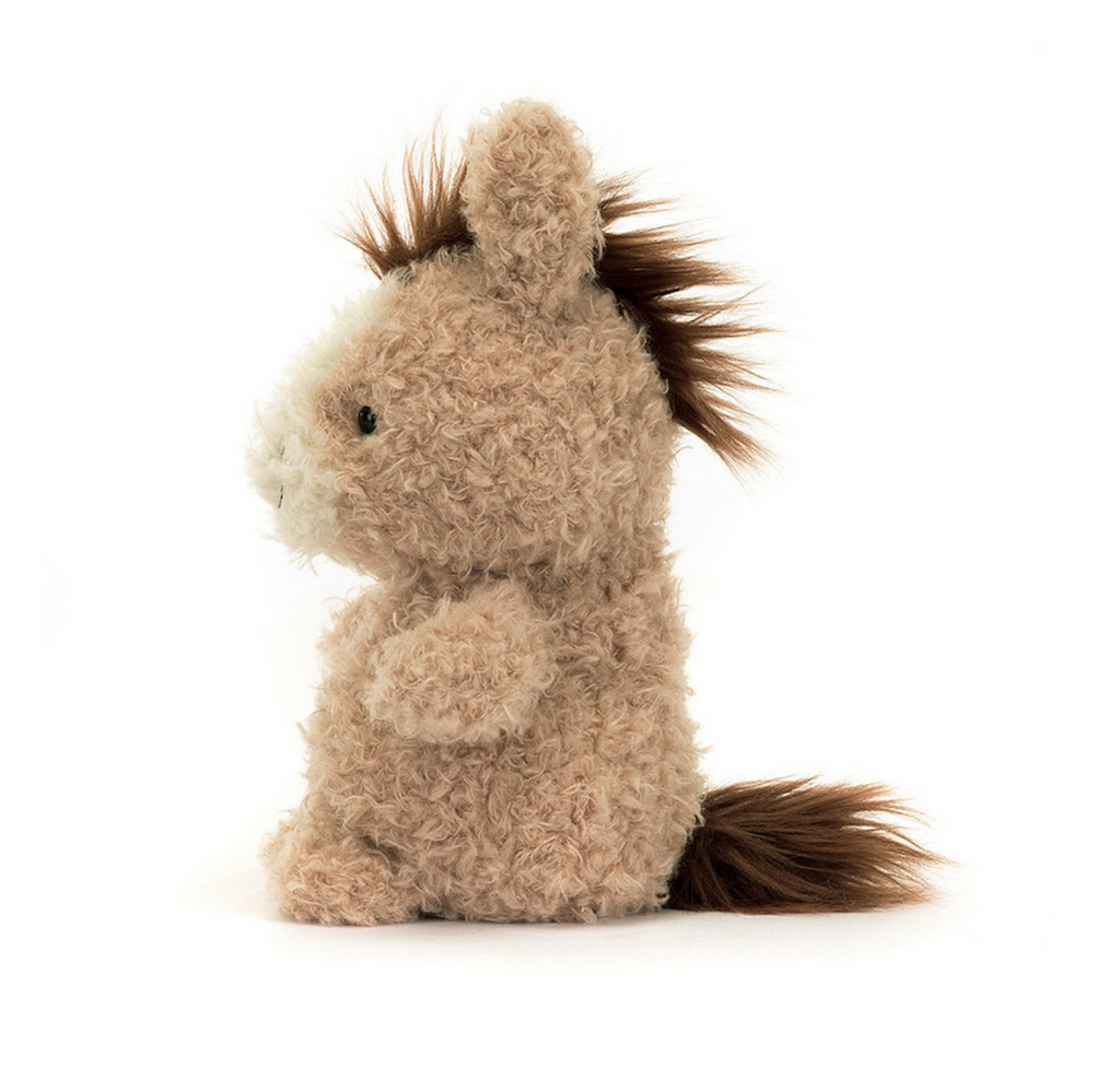 Little Horse stuffed animal viewed from the side with scruffy fur, brown mane and tail. 